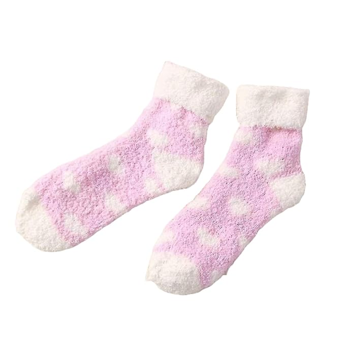 Cute pink socks decorated with white hearts, perfect for a cozy day at home or a fun outing.