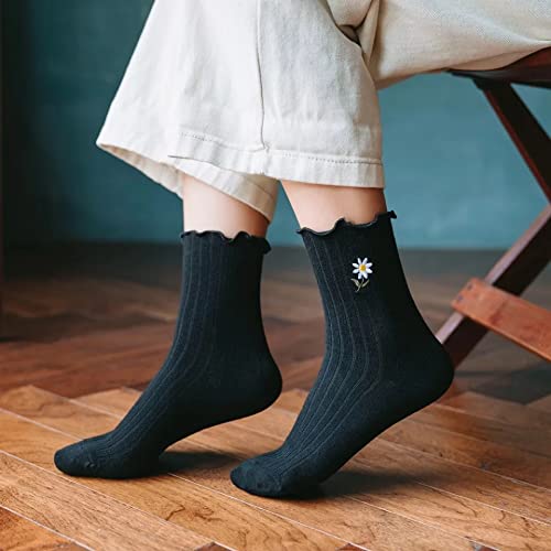 A woman's feet in black socks featuring a cute daisy pattern.