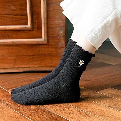 A close-up of a woman's feet in black socks adorned with cheerful daisies.