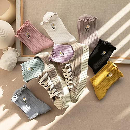 A woman in white trousers and sneakers poses, embodying a blend of comfort and contemporary fashion.