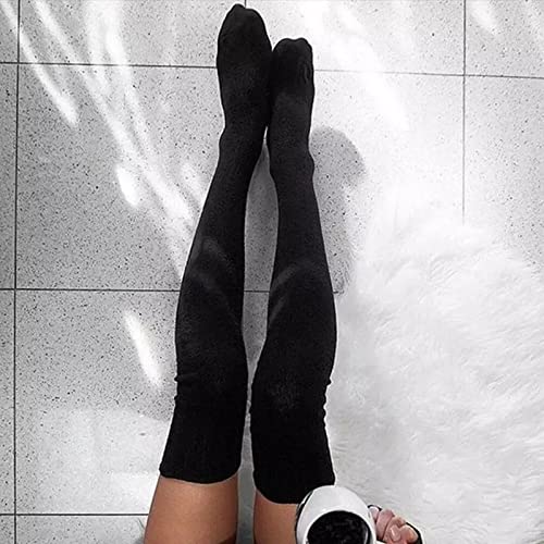 A woman in black stockings enjoys a warm cup of coffee, smiling as she takes a moment to relax.