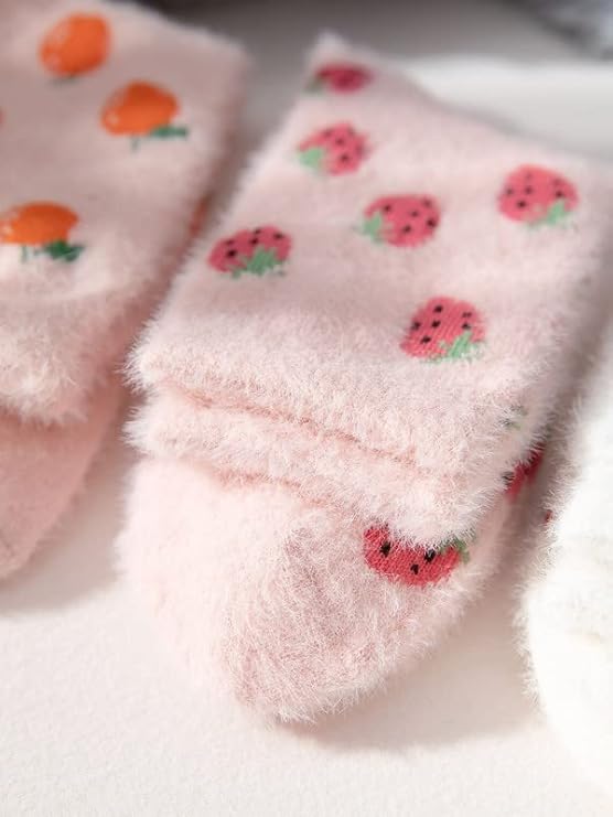 Stylish pink socks with cute strawberry prints, perfect for keeping your feet warm and trendy.