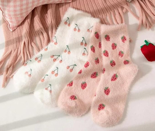 A vibrant pair of pink socks featuring adorable strawberry designs, ideal for cozying up in style.