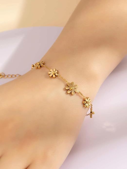 Gold necklace with four flower charms, perfect for adding a touch of elegance to any outfit.