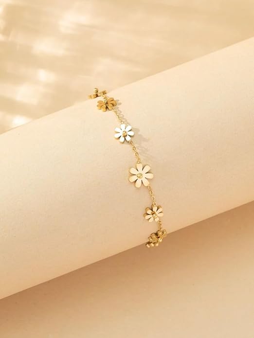 Elegant gold necklace with four delicate flower embellishments.