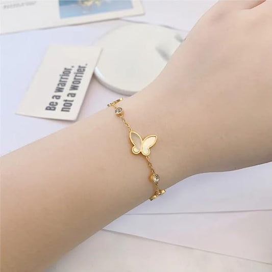 Woman's wrist with gold butterfly bracelet, elegant accessory for a touch of nature-inspired glamour.