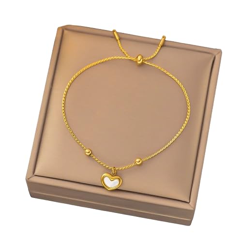 Gold heart charm bracelet displayed on top of a box.