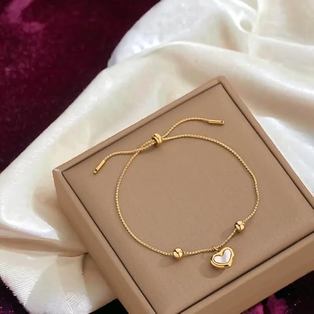 A box with a gold heart charm bracelet.