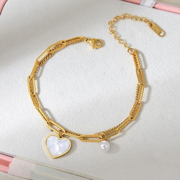 Fashionable gold bracelet with heart charm and pearl, perfect for any occasion.