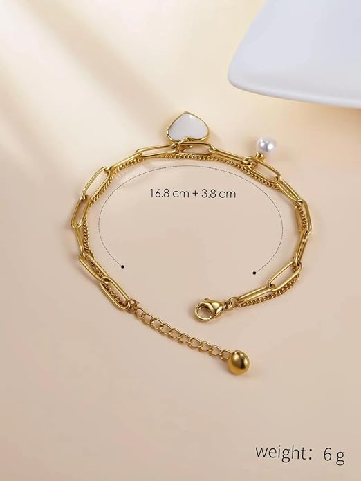 A gold bracelet with heart charm and pearl, perfect for any occasion.