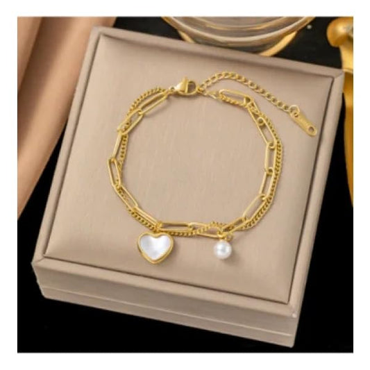 Gold bracelet with heart charm and pearl, elegant jewelry accessory.