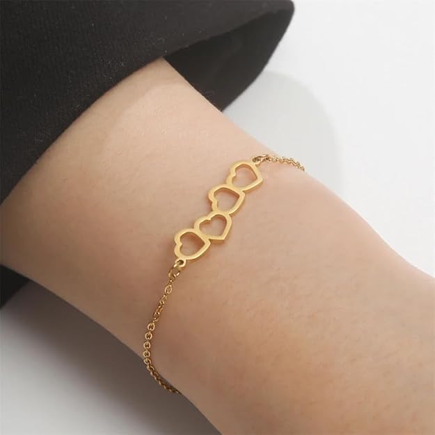  Gold wrist accessory with two heart decorations.