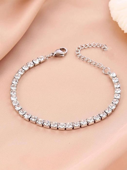 A stunning diamond tennis bracelet placed on a blue backdrop.