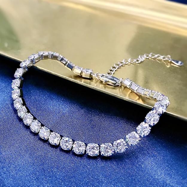  A diamond tennis bracelet on a gold tray.