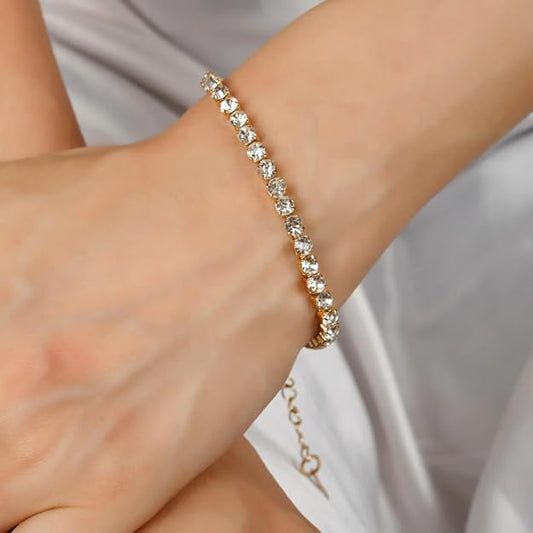 Woman with gold bracelet adorned with diamonds.