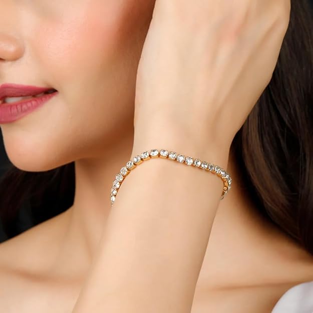 Gold bracelet with sparkling diamonds on woman's wrist.