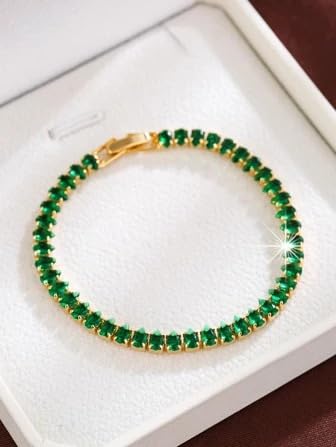 Luxurious emerald green bracelet resting in a white box.