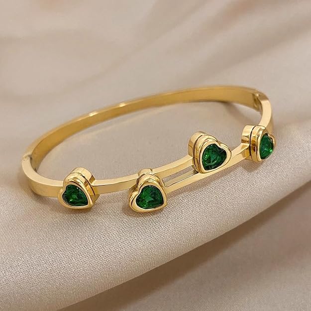 Elegant bracelet featuring gold plating and beautiful green gemstones.