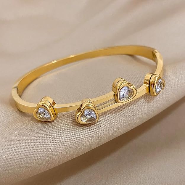 Gold plated bracelet with three heart charms, perfect for adding a touch of elegance to any outfit.