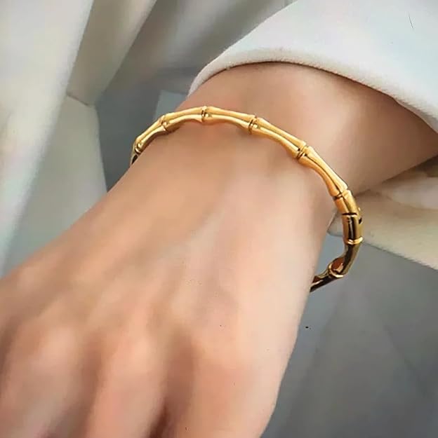 Gold bracelet featuring delicate bamboo leaves design.