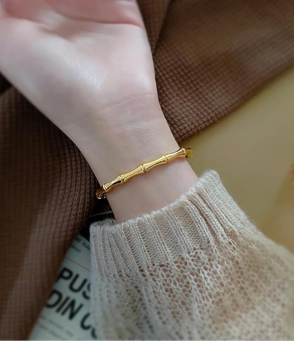 Stylish gold bracelet with intricate bamboo leaf pattern.