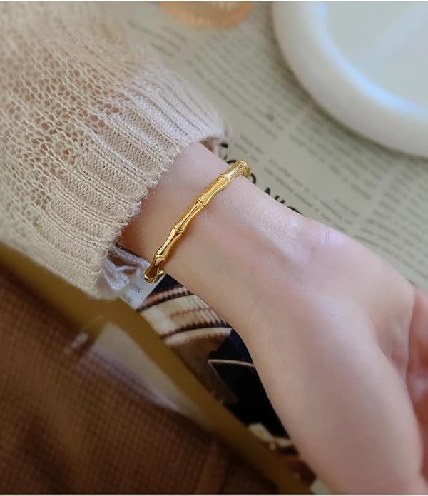 Dainty gold bracelet showcasing beautiful bamboo leaves.