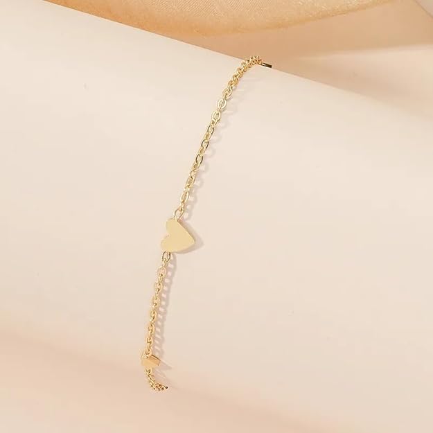 A fashionable gold chain bracelet with heart motifs.