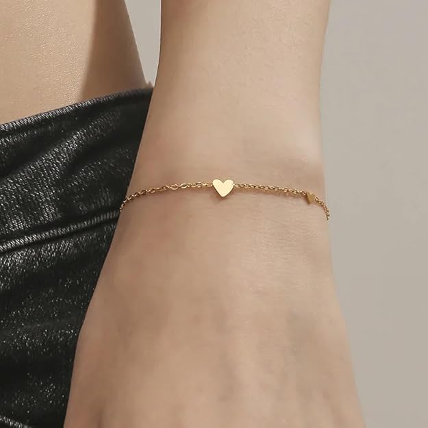 A bracelet featuring gold chain and heart-shaped charms.