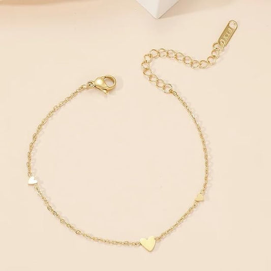 A gold chain bracelet with heart-shaped charms.