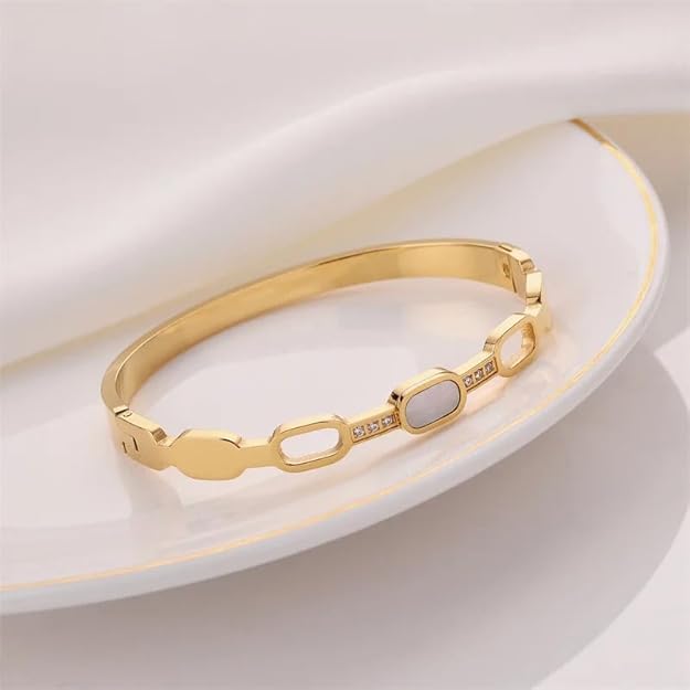 Stylish gold bracelet adorned with white stones, perfect for formal events.