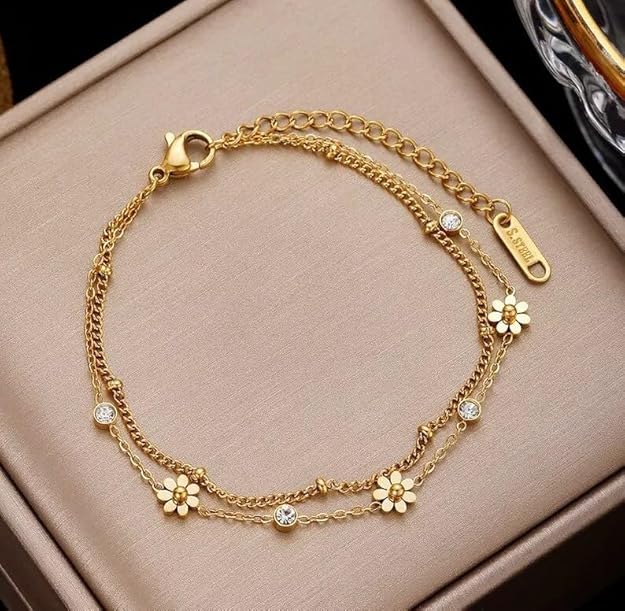 A gold plated daisy chain bracelet with intricate floral links.