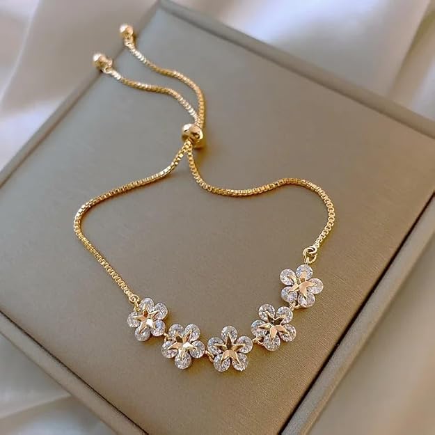  Gold plated bracelet with delicate flower designs.