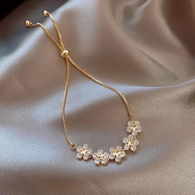 A gold plated bracelet with delicate flower designs.