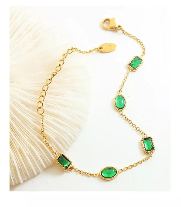 Gold chain bracelet with green stones, perfect for adding a touch of elegance to any outfit.