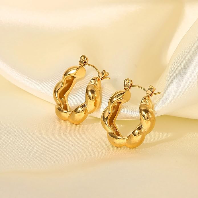 Shiny gold plated hoop earrings on a white background.