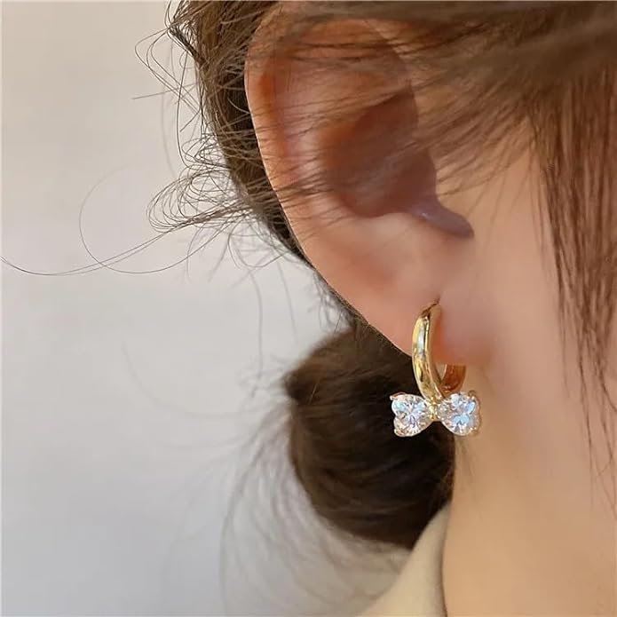 Stylish earrings featuring gold plating and white crystals.