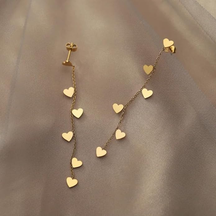 Gold heart earrings with small charms, perfect for adding a touch of elegance to any outfit.