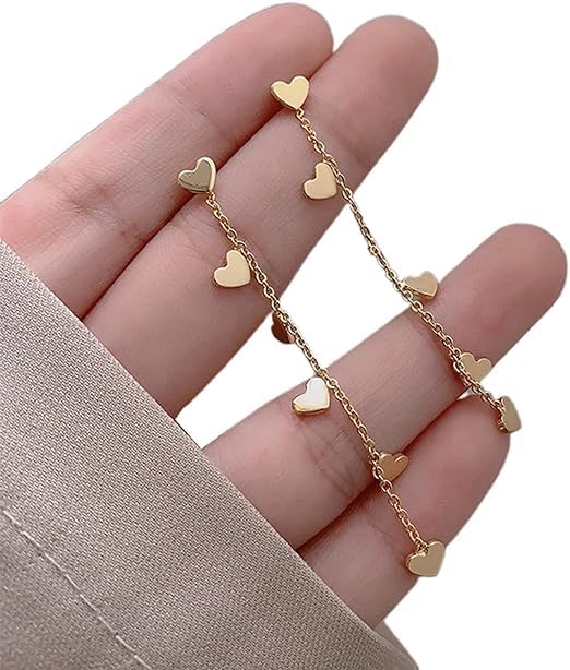 Gold heart earrings with small charms, perfect for adding a touch of elegance to any outfit.