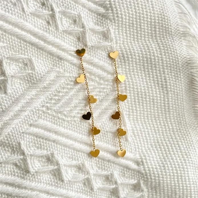  Dainty gold heart earrings adorned with charming details, a lovely accessory for any occasion.