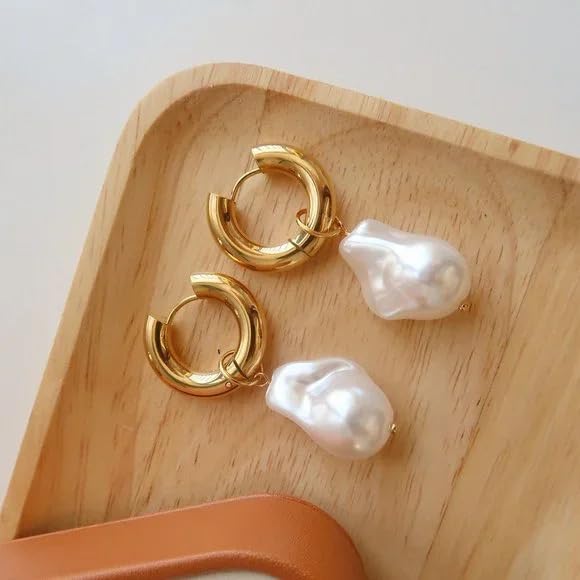 Gold hoop earrings with white pearls, elegant jewelry for a sophisticated look.