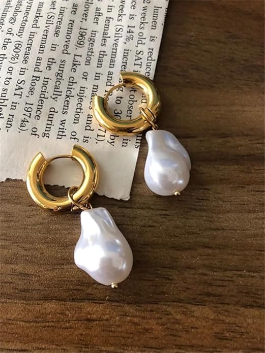 Gold hoop earrings embellished with white pearls, a timeless and chic accessory choice.