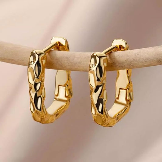 Shiny gold plated hoop earrings on a white background.