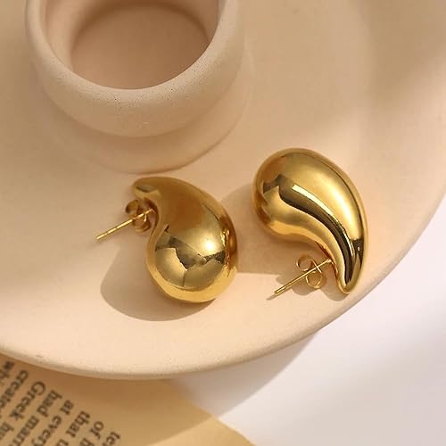 Elegant gold tone tear drop earrings with delicate design.