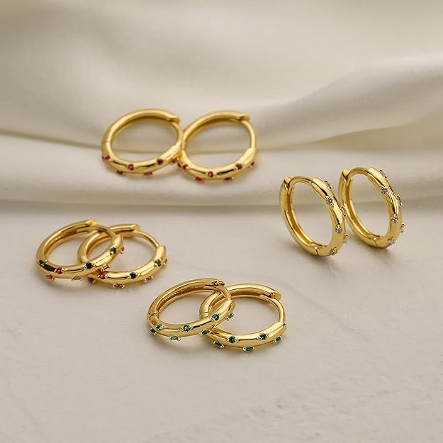 Beautiful gold hoops featuring emerald stones