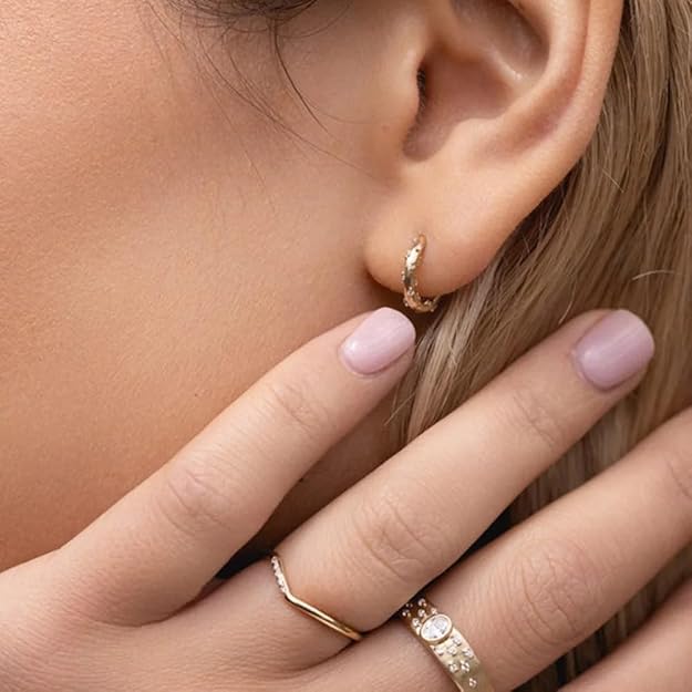 Chic gold hoops with stunning diamond accents, the ultimate statement piece for any ensemble.