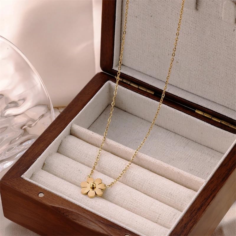  A gold necklace with a delicate flower charm.