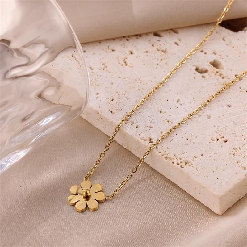 A gold necklace with an elegant floral charm.