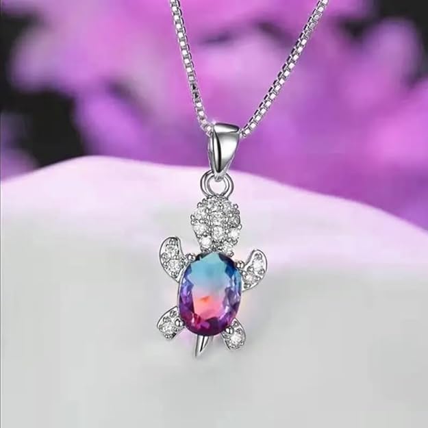 Necklace featuring a turtle charm and a rainbow crystal.