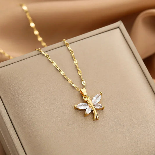 Gold butterfly necklace with white stone, elegant jewelry piece for special occasions.