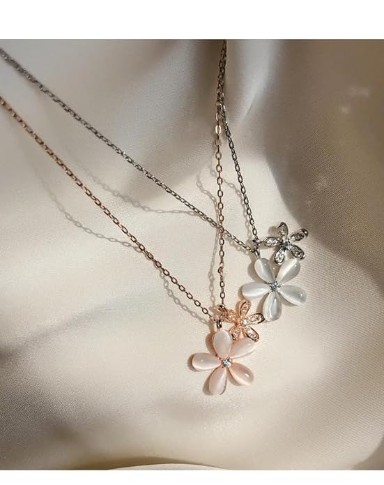 White flower necklace with pink flower pendant.